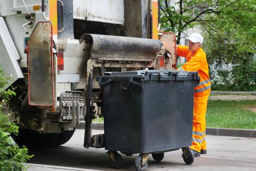 Crew loading garden waste into a vehicle with PPE